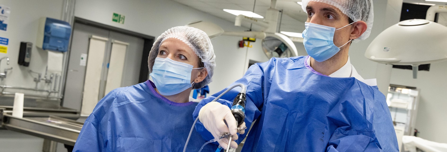 two surgeons with a medical device